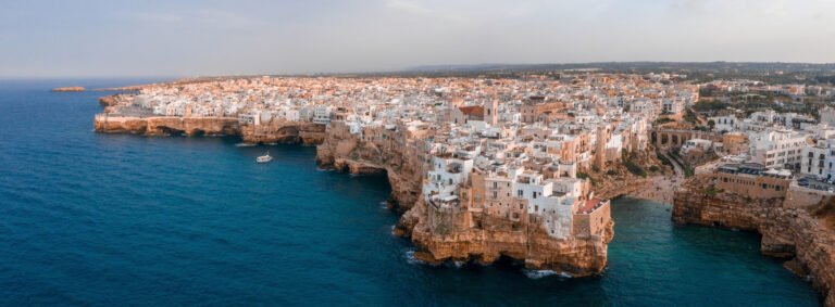 aerial shot of an ancient city with old building and houses on the top of rocky hills